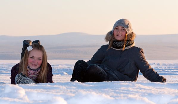 Two young beautiful girl in the snow