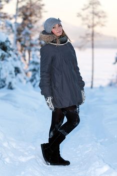 portrait of a beautiful young girl in the sunlight in the cold