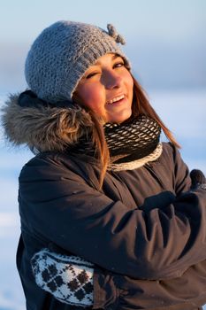 portrait of a beautiful young girl in the sunlight in the cold