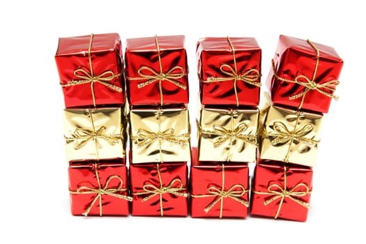 Gift red boxes with gold bows on a white background