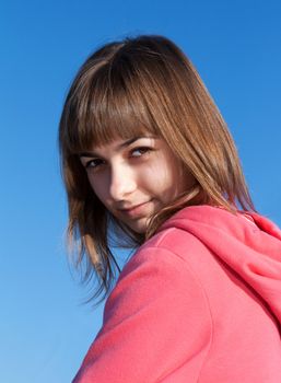 portrait of a beautiful young woman against the sky