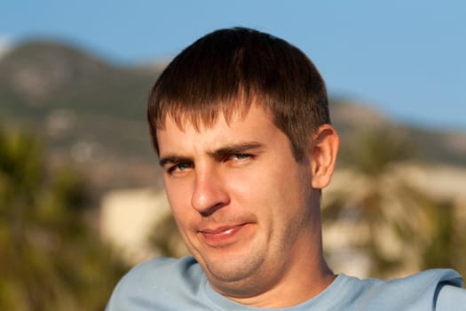 portrait of a man against the backdrop of greenery