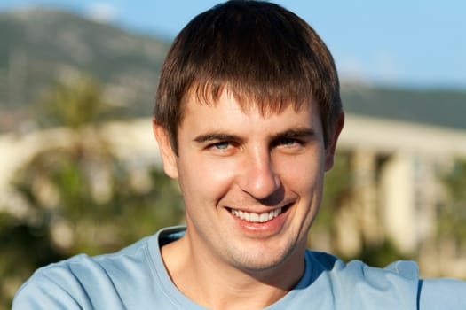 portrait of a man against the backdrop of greenery