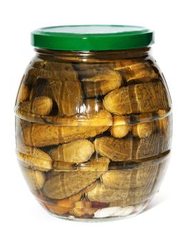 Glass bank with salty cucumber on white background