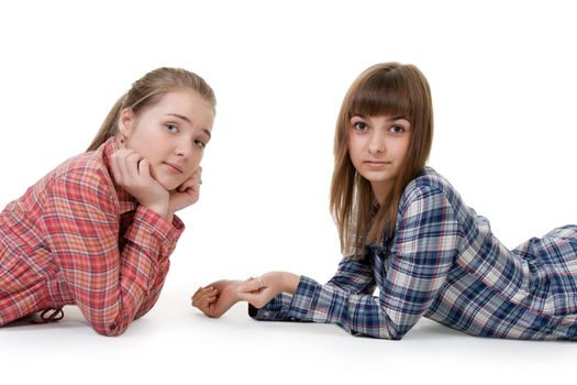 Two young beautiful girls lying on the floor