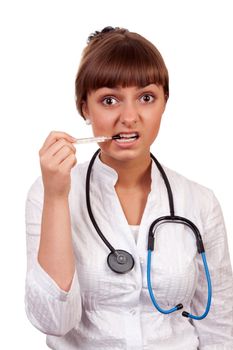 beautiful young woman doctor with a thermometer isolated on white background