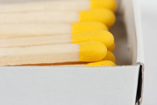 open boxes of wooden matches and yellow-head