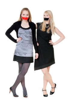 Two beautiful girls with their mouths taped with tape