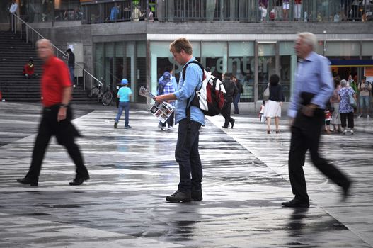 Stockholm, Sweden July 20 2012. Every year 7 million tourists are visiting the capital of Sweden. Man reading map down town Stockholm.