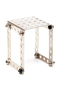Steel building kit with bolts and nuts on white background