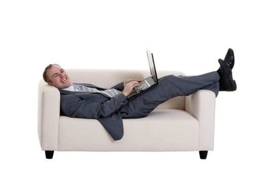 businessman lying on the couch with a laptop on a white background