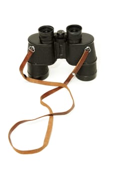 Old black glasses with a leather strap on a white background