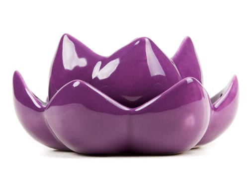 Candle in the form of porcelain violet isolated on a white background