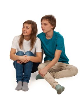boy and girl sitting on the floor on a white background