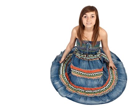 girl sitting on the floor in the denim dress with a white background