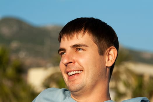 portrait of a man against the backdrop of greenery