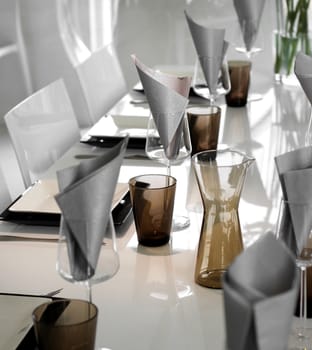 Dining table setting with modern glasses and plates