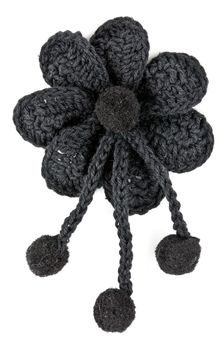 black knitted fabric flower on a white background