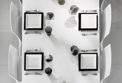 Modern black and white dining table setting seen above