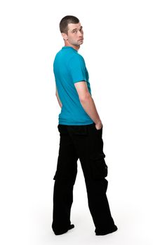 man in a full-length white background turns from a shoulder