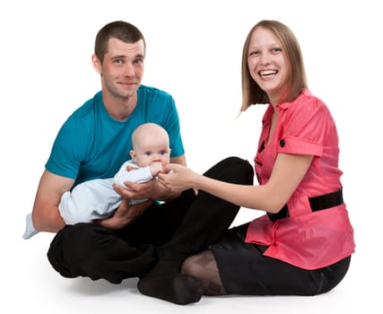 Mom and Dad with a baby sitting on a white floor