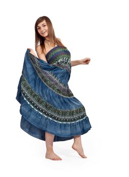 beautiful girl in jeans sarafan dancing on a light background