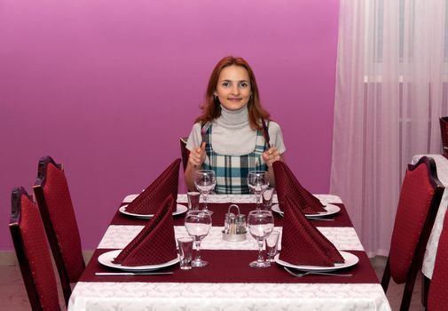 Beautiful girl in a restaurant with a purple design