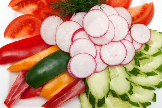 vegetables sliced ​​piled a heap on a white plate