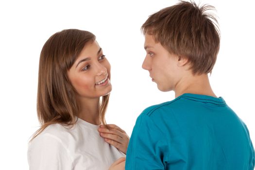 pair of teenagers looking at each other on a white background