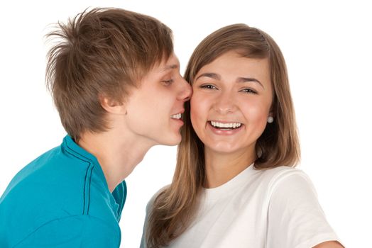 boy kisses a girl in studio on white background