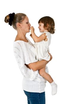 little girl at the hands of the mother feeds her and plum in a studio isolated on a white background