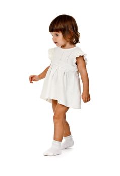 little girl in a knitted dress in the studio on a white background