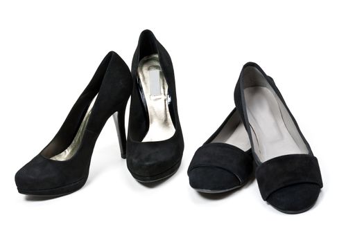 two pairs of female black suede shoes isolated on white background