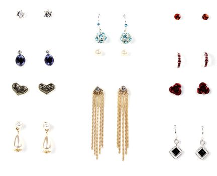 several pairs of earrings with stones on a white background