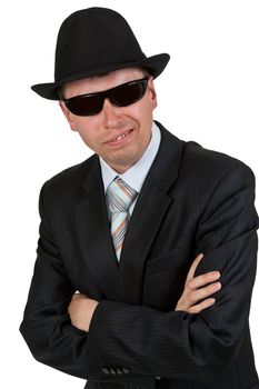 businessman in dark glasses and a hat on a white background