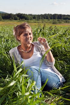 portrait of a beautiful girl in the green grass