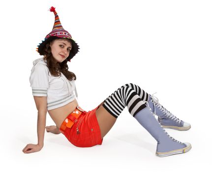 girl in striped socks and orange mini skirt sitting on a white floor