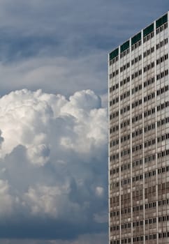 High building and bulk cumulus clouds in the sky
