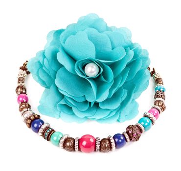 turquoise fabric flower and color bracelet on white background