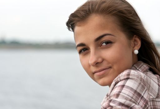 portrait of a beautiful girl on the background of the horizon