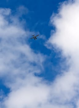 seaplane flying in the sky with clouds