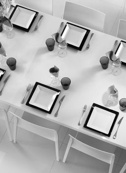 Modern black and white dining table setting seen above