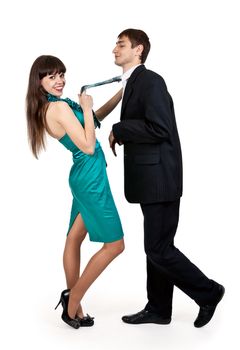 girl in a blue dress holds a businessman in tie