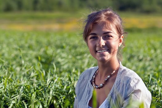 portrait of a beautiful girl in the green grass