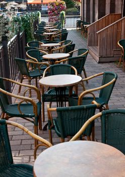 empty restaurant on a street in the morning shadows