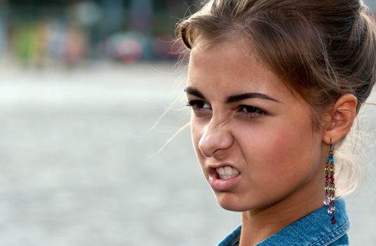 portrait of beautiful girl in the denim vest in the square
