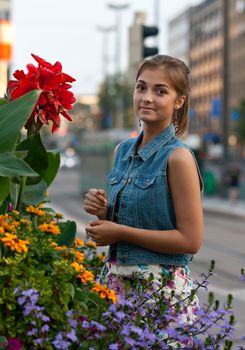 portrait of a girl in a denim vest with flowers