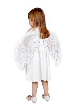 little girl with angel wings in back in the studio on a gray background