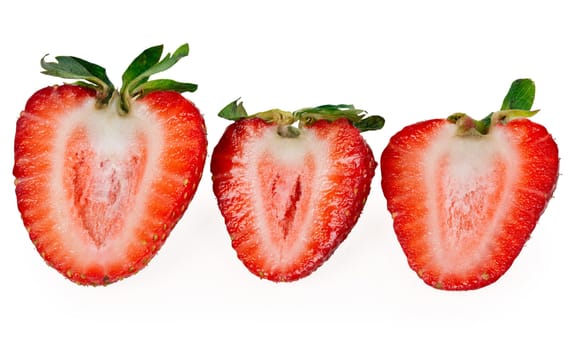three delicious strawberry halves isolated on a white background