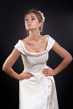 girl in a wedding dress in the studio on a black background